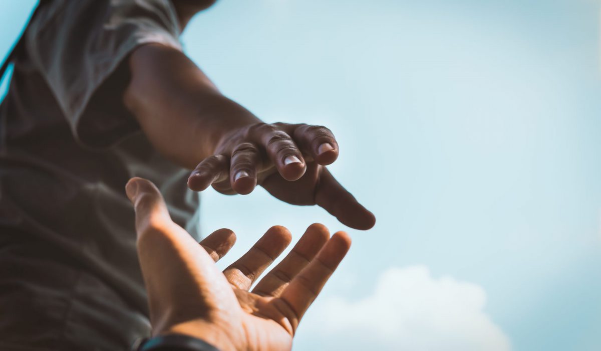 hands-reaching-out-help Help Concept hands reaching out to help each other in dark tone